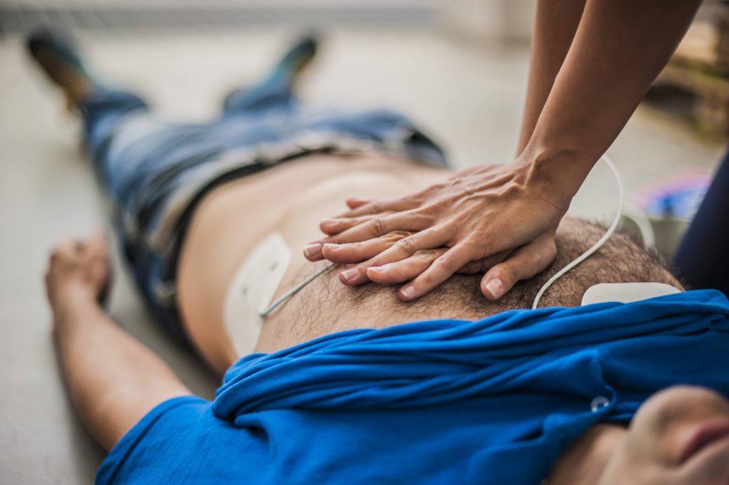 Doing CPR and using an AED
